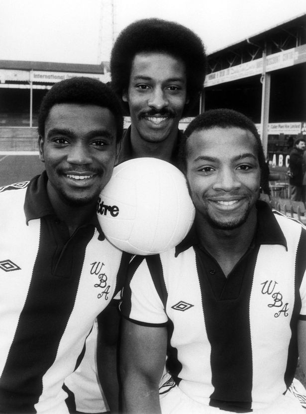 Black and white picture of three blackfootballers